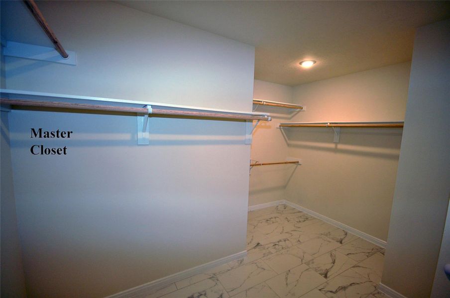 Enjoy expansive hanging and storage in the master closet.