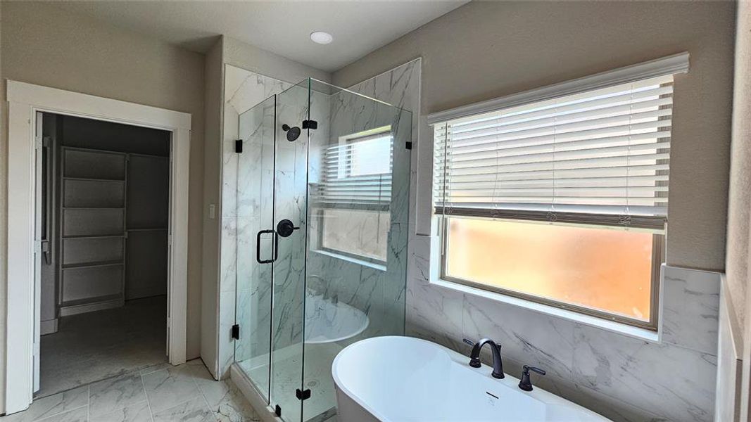 Bathroom featuring independent shower and bath and tile patterned flooring