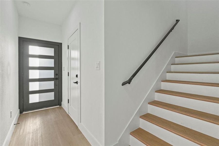 Foyer entrance with light wood-style floors and stairs Foyer entrance with light wood-style floors and stairs