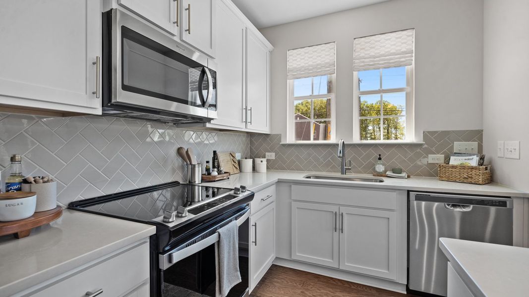 Bright kitchen with large window, quartz countertops, and undermount sink in the Rochester Design by DRB Homes Charlotte, NC Bright kitchen with large window, quartz countertops, and undermount sink in the Rochester Design by DRB Homes Charlotte, NC