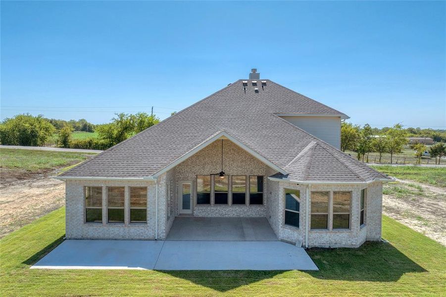 Back of house featuring a yard and a patio area