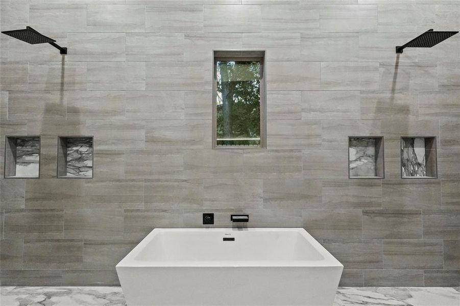 Bathroom featuring tile walls and independent shower and bath