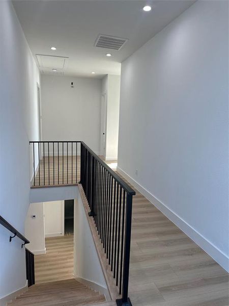 Staircase featuring wood-type flooring