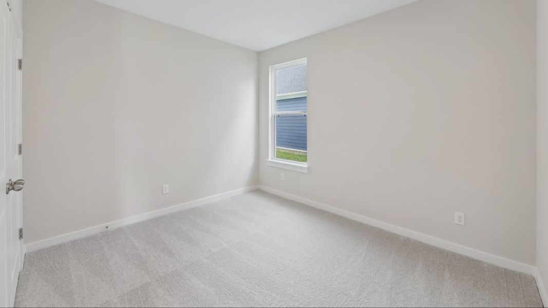 Secondary Bedroom with carpet and window