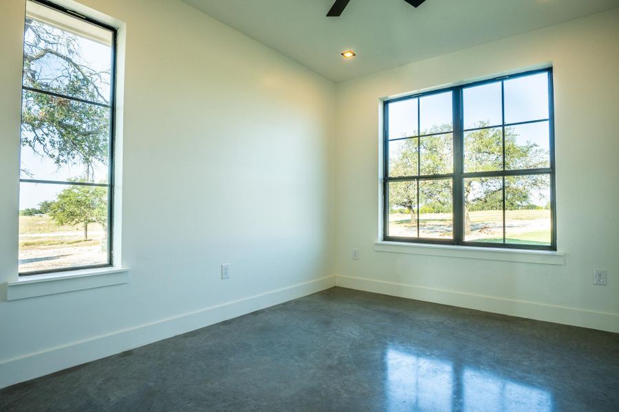 Spare room with concrete flooring, a ceiling fan, and recessed lighting