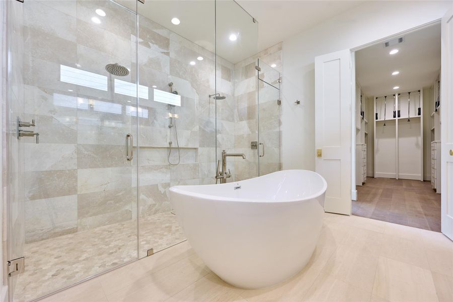 Luxurious primary bath featuring an elegant oval-shaped soaking tub. Luxurious primary bath featuring an elegant oval-shaped soaking tub.