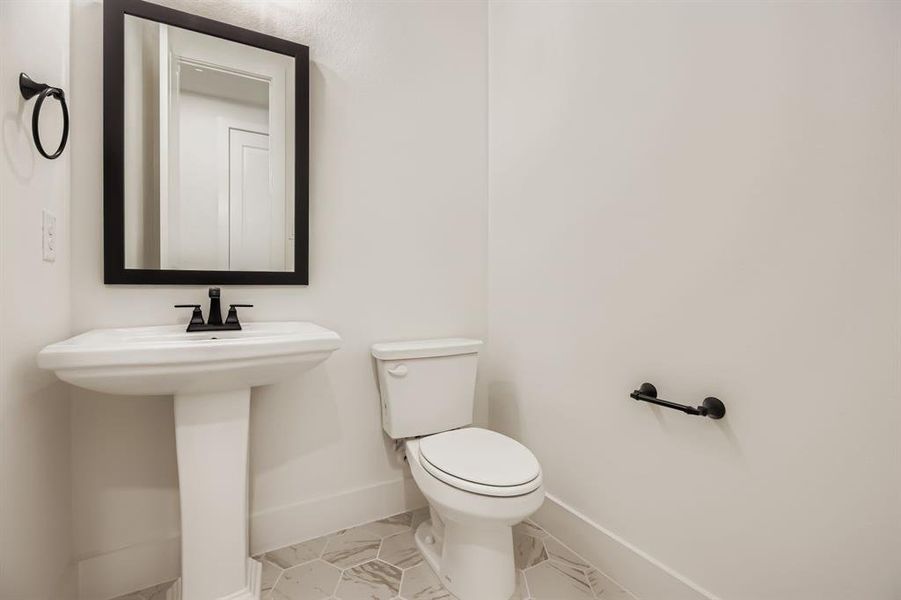 Bathroom with toilet and tile patterned floors Bathroom with toilet and tile patterned floors