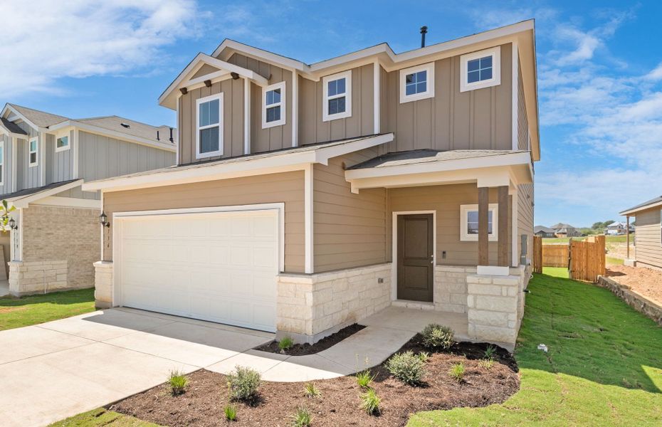 Front exterior of a new home in Sunfield, Buda, TX, highlighting curb appeal (Image 18). Front exterior of a new home in Sunfield, Buda, TX, highlighting curb appeal (Image 18).