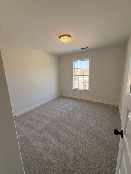 Unfurnished room with carpet and baseboards