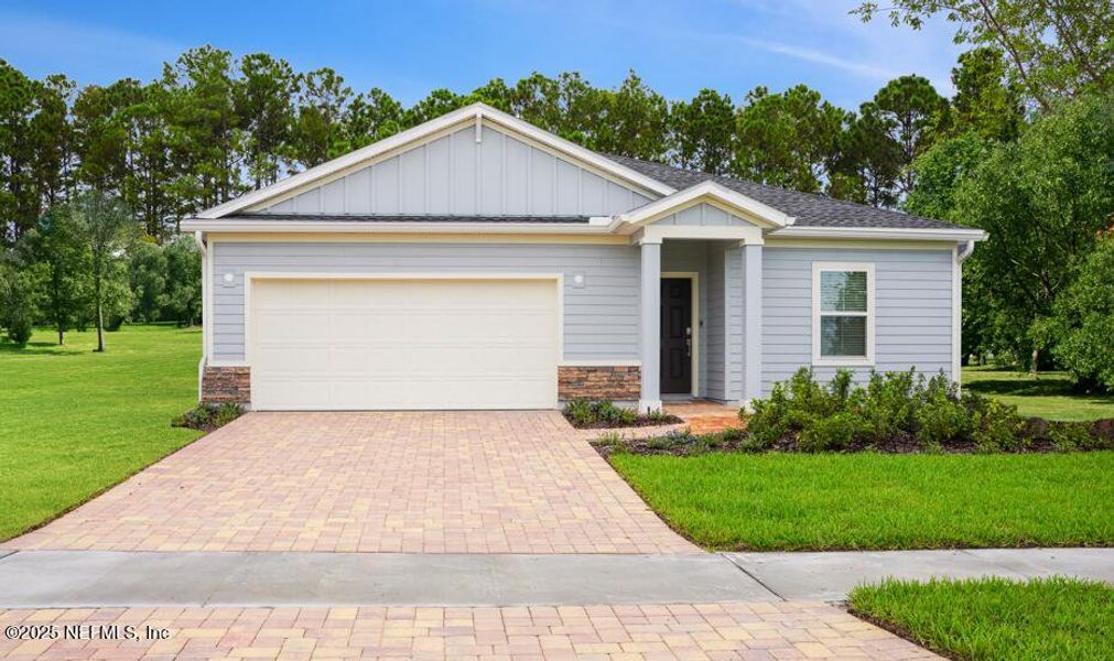 Front exterior of a new home in Edenbrooke at Hyland Trail | 55+: Edenbrooke at Hyland Trail 50s, Green Cove Springs, FL, highlighting curb appeal (Image 1).