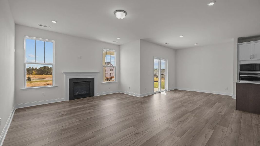 Fairfield design open concept family room, eat-in breakfast, and gourmet kitchen at Lakeside Glen by DRB Homes, York, SC.