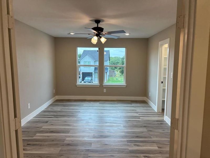 Unfurnished room featuring light wood-style flooring and ceiling fan Unfurnished room featuring light wood-style flooring and ceiling fan