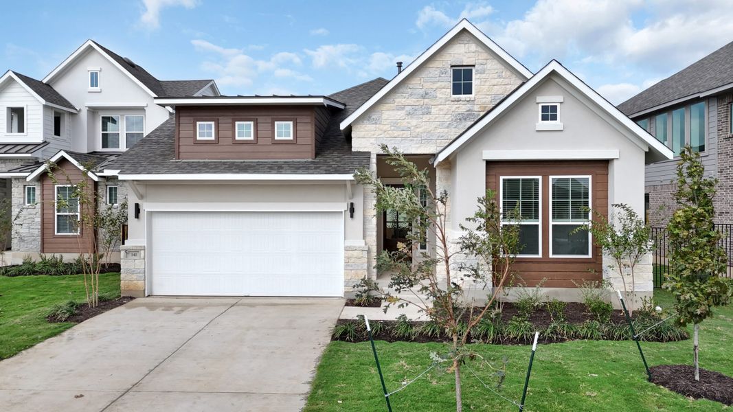Front exterior of a new home in Santa Rita Ranch, Liberty Hill, TX, highlighting curb appeal (Image 25).