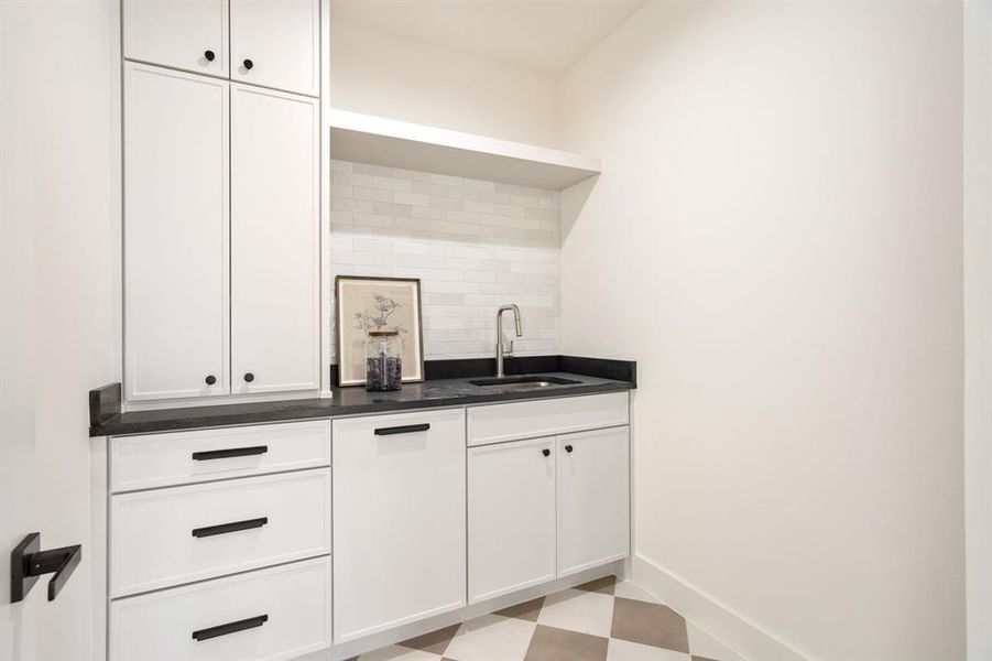 2nd Laundry Upstairs featuring light flooring, white cabinets, tasteful backsplash, open shelves, and dark stone counters 2nd Laundry Upstairs featuring light flooring, white cabinets, tasteful backsplash, open shelves, and dark stone counters
