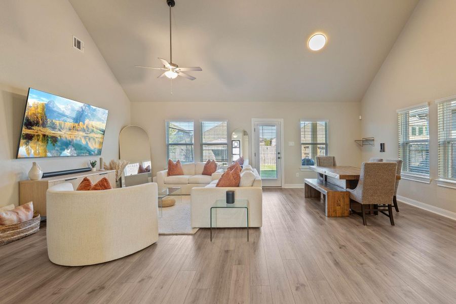 This spacious living area features high ceilings, large windows for natural light, and elegant wood flooring. The open layout includes a cozy seating area adjacent to a stylish dining space, creating a welcoming and functional environment. This spacious living area features high ceilings, large windows for natural light, and elegant wood flooring. The open layout includes a cozy seating area adjacent to a stylish dining space, creating a welcoming and functional environment.