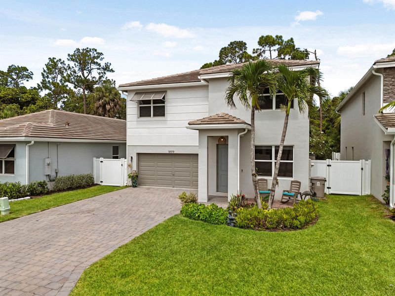 Front exterior of a new home in Reserve at Jupiter, Jupiter, FL, highlighting curb appeal (Image 24).