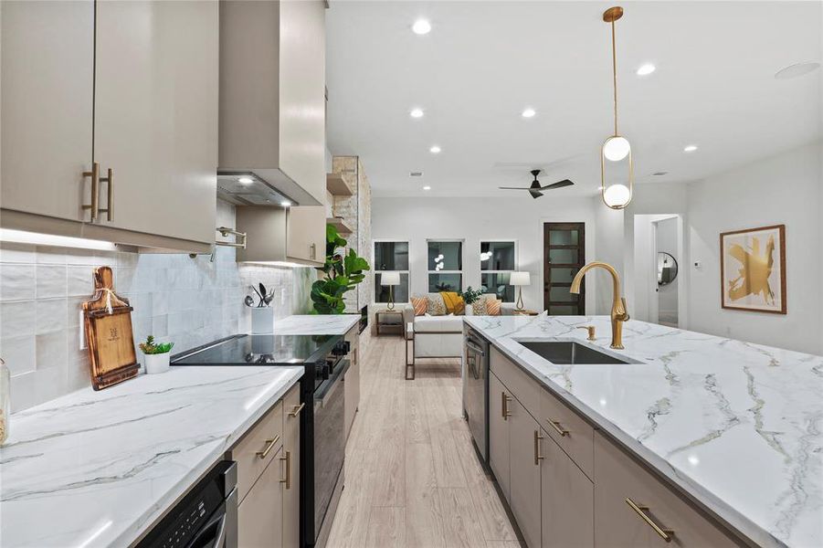 Kitchen featuring pendant lighting, island range hood, sink, gray cabinetry, and black range with electric stovetop