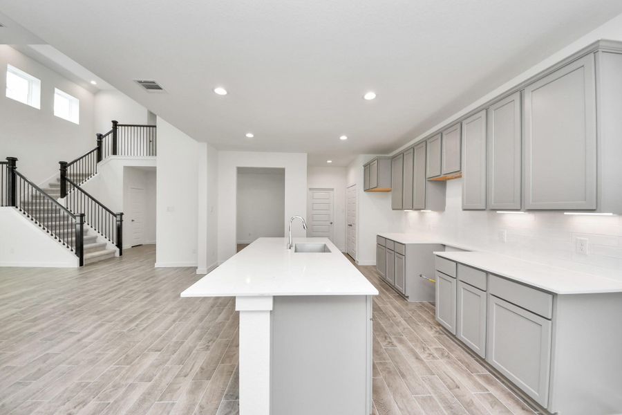 The open concept effortlessly connects the kitchen to the expansive family room, forming a perfect hub for gatherings. This seamless flow creates an inviting space where cooking and socializing come together harmoniously. Sample photo of completed home with similar floor plan. Actual colors and selections may vary. The open concept effortlessly connects the kitchen to the expansive family room, forming a perfect hub for gatherings. This seamless flow creates an inviting space where cooking and socializing come together harmoniously. Sample photo of completed home with similar floor plan. Actual colors and selections may vary.