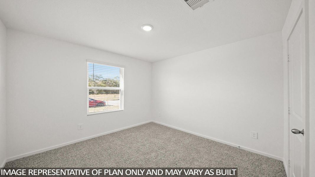 A well-lit room awaits your personal touch, featuring soft carpet and a window with natural illumination.
