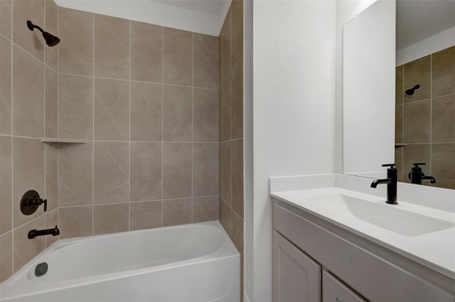 Bathroom featuring vanity and  shower combination