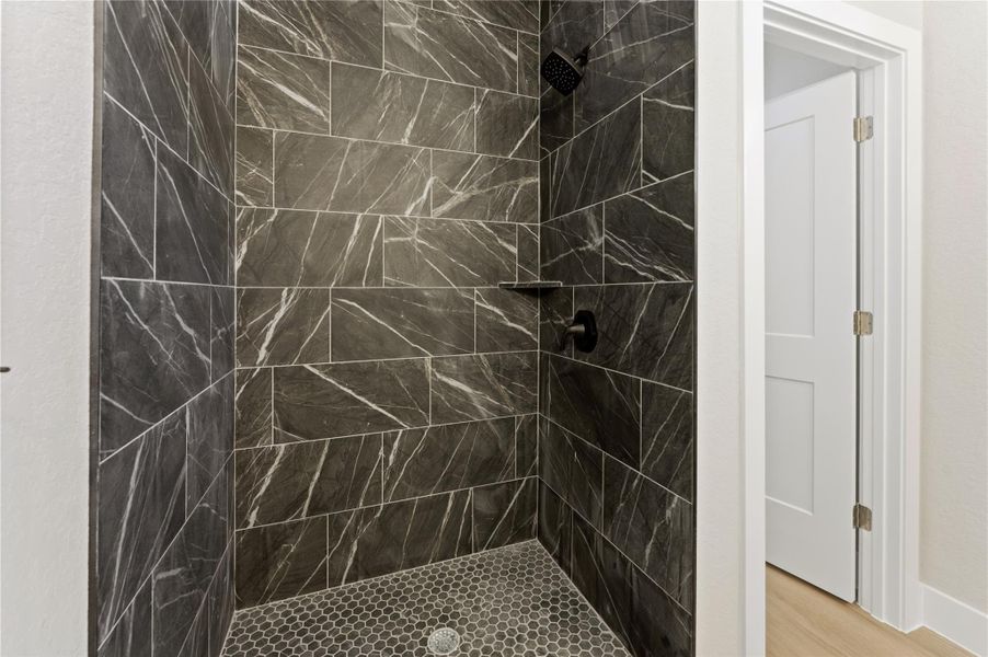 Bathroom featuring a stall shower and light wood-style floors