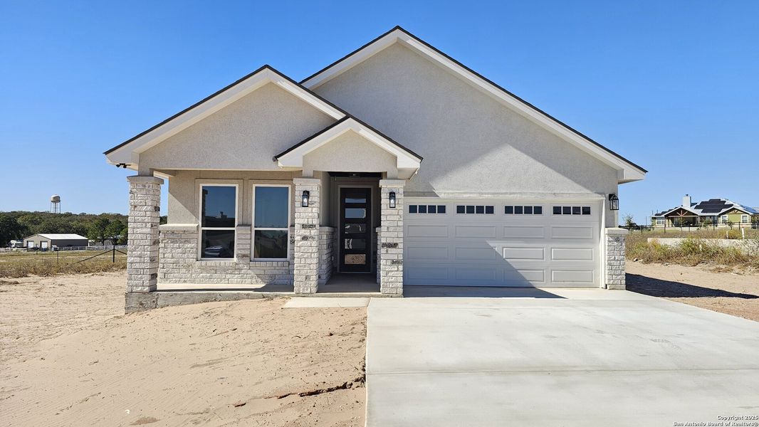 Front exterior of a new home in , La Vernia, TX, highlighting curb appeal (Image 25).