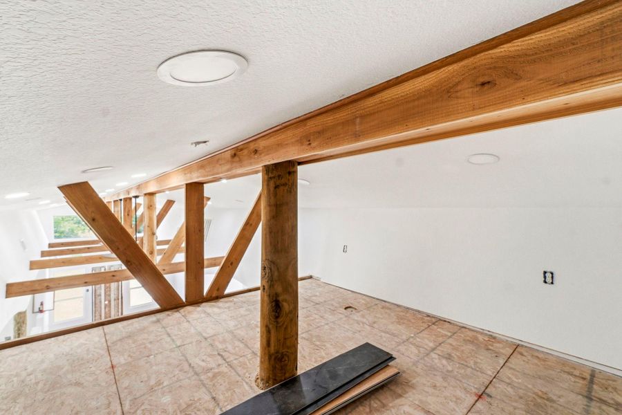 Views from the second level loft that overlooks the main living areas. This room is perfect for additional storage space or playroom for the kiddos!