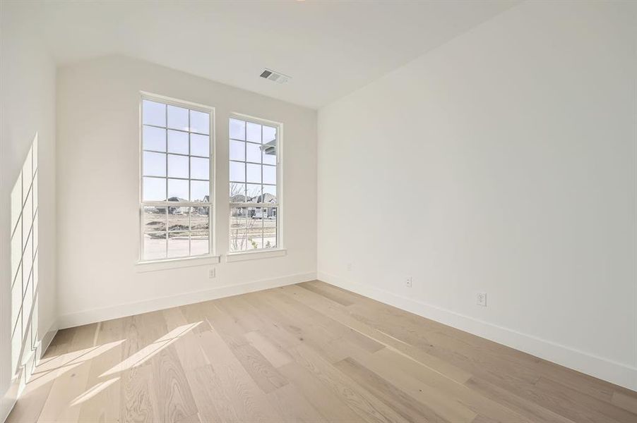 Unfurnished room with light hardwood / wood-style floors