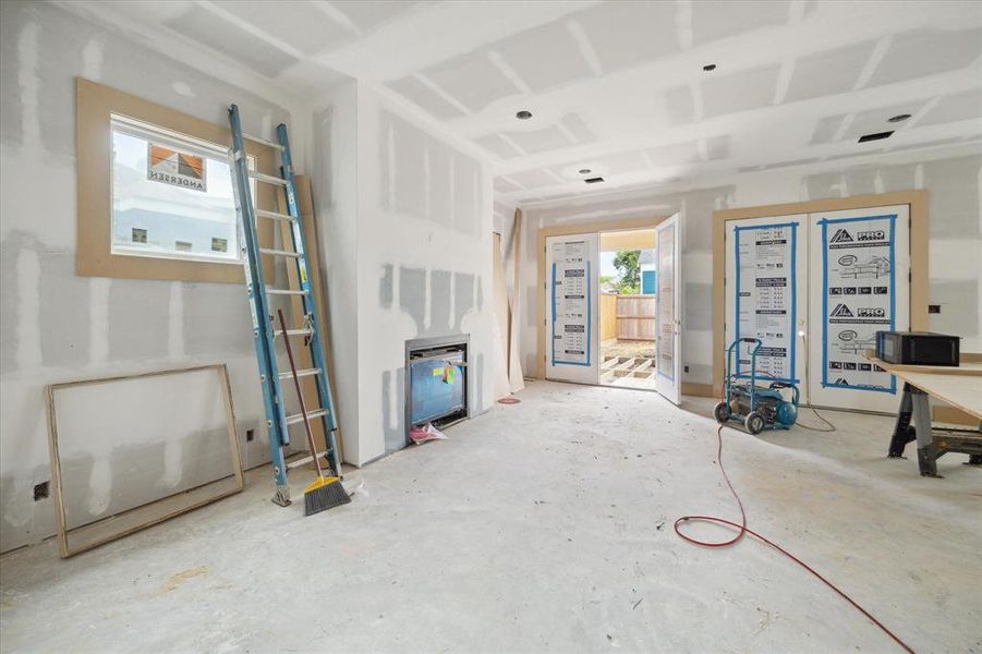 Another view of the dual French doors leading to the backyard, offering a glimpse of seamless indoor-outdoor living.