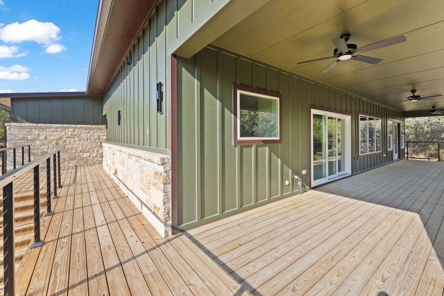 Main level porch wraps around the side and front and has an exterior stair case leading to the lower level.