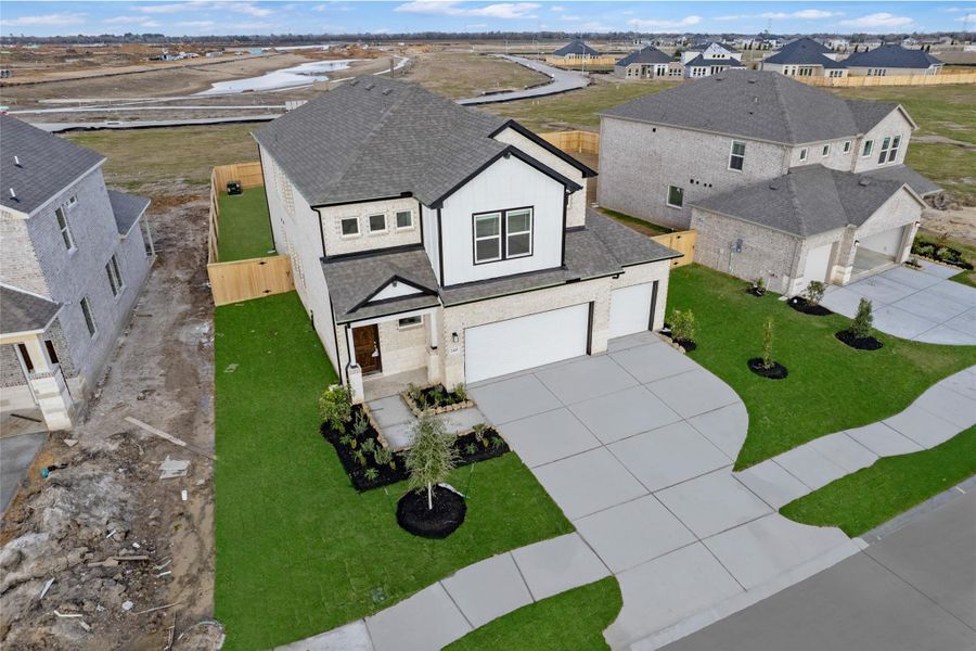 Front exterior of a new home in Creekhaven, Iowa Colony, TX, highlighting curb appeal (Image 22).