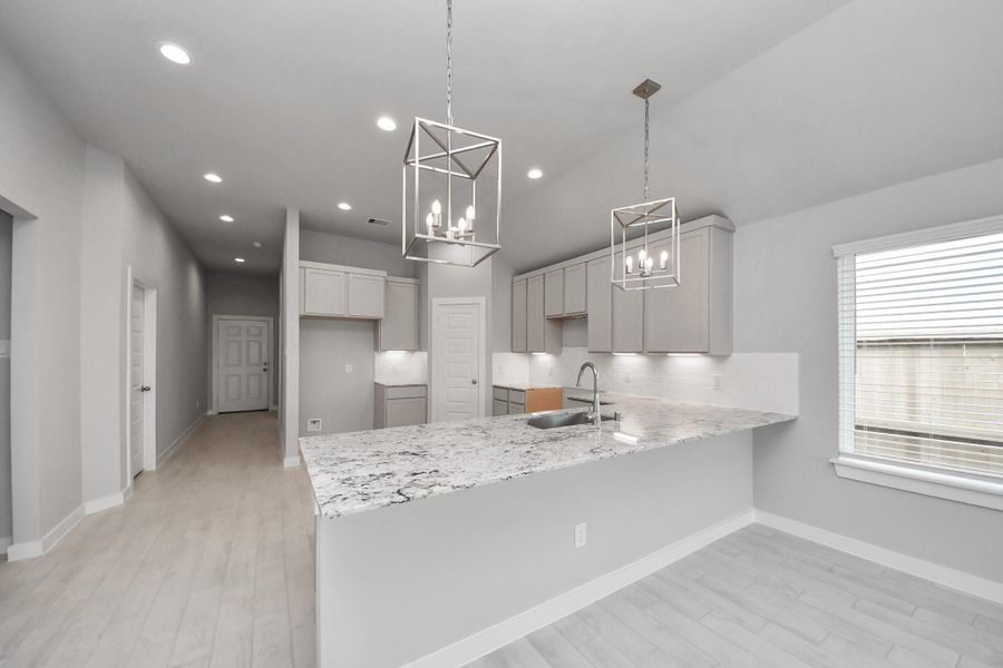 All of this overlooks your expansive family room, creating a perfect space for culinary delights and family gatherings. Sample photo of completed home with similar floor plan. Actual colors and selections may vary.