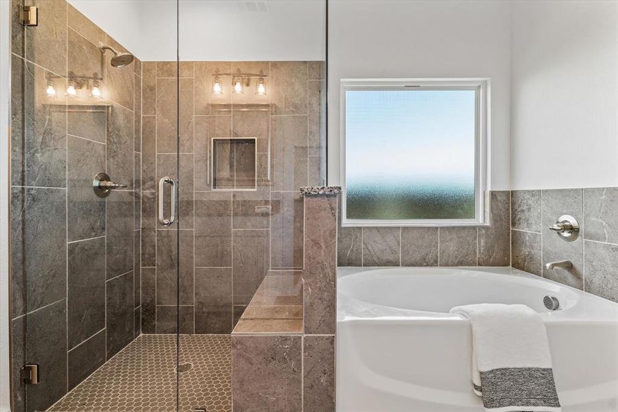 Bathroom featuring shower with separate bathtub
