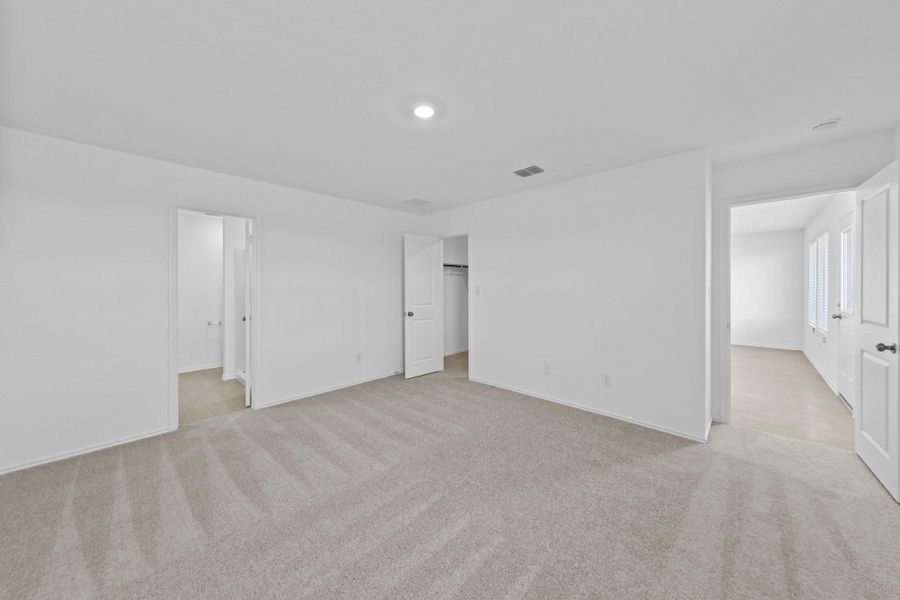 Unfurnished bedroom with light carpet