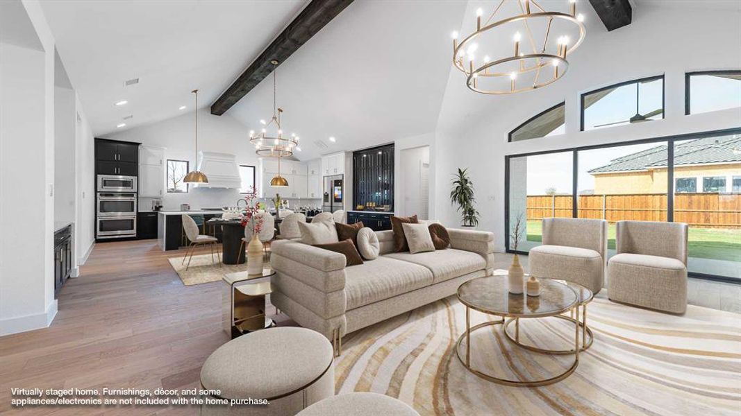 Living room featuring high vaulted ceiling, beamed ceiling, and wood-type flooring