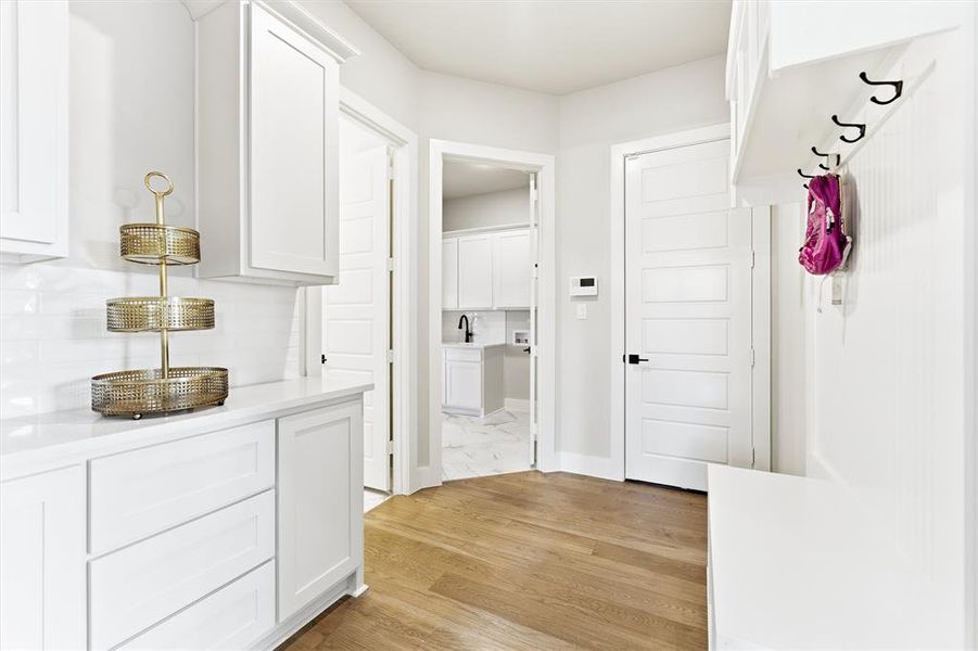 Mudroom featuring light wood-style floors