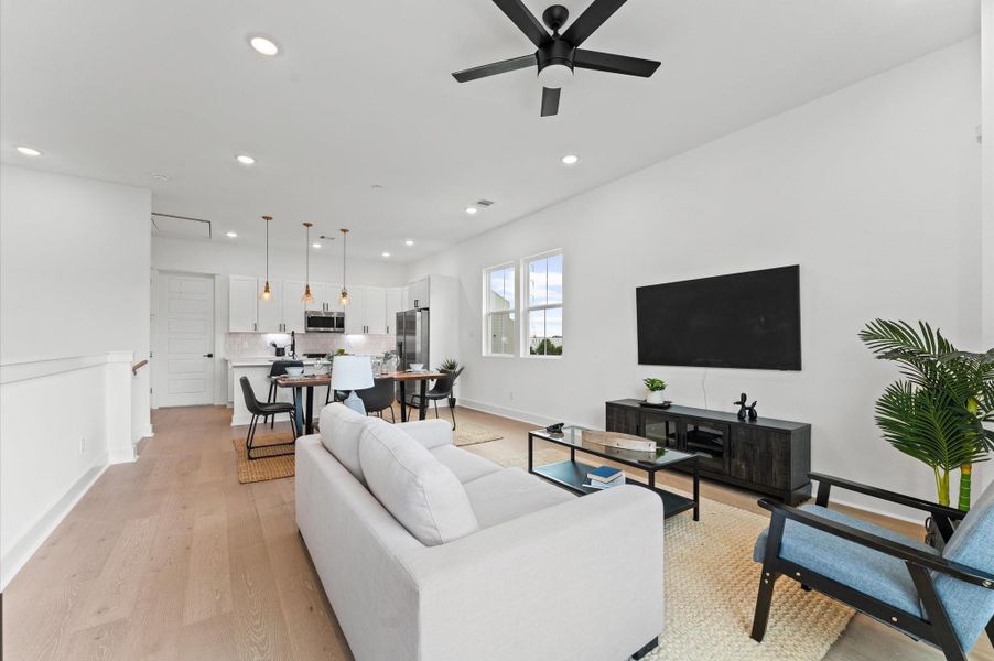 This thoughtfully designed two-story residence features a unique layout that places the living room, kitchen, and dining area on the second floor, creating a bright and airy space ideal for entertaining. Expansive windows flood the open-concept floor with natural light, while sleek finishes and modern fixtures add a touch of sophistication.