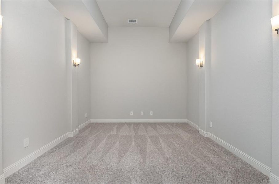 Empty room featuring light colored carpet