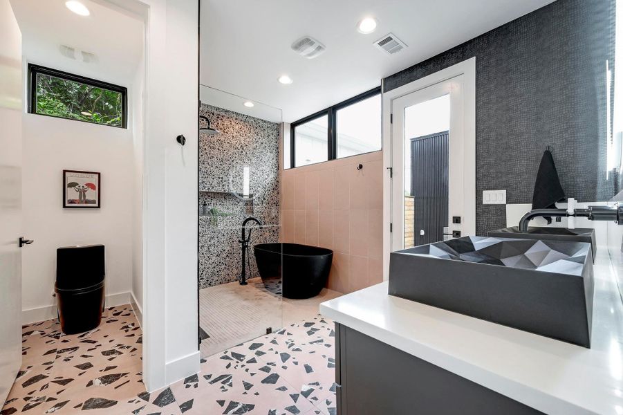 Bathroom featuring a stall shower, a freestanding bath, recessed lighting, light tile patterned floors, and vanity
