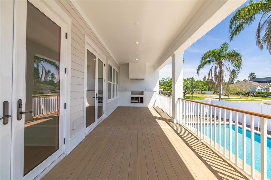 This covered outdoor living area has access through the downstairs guest room and the great room.