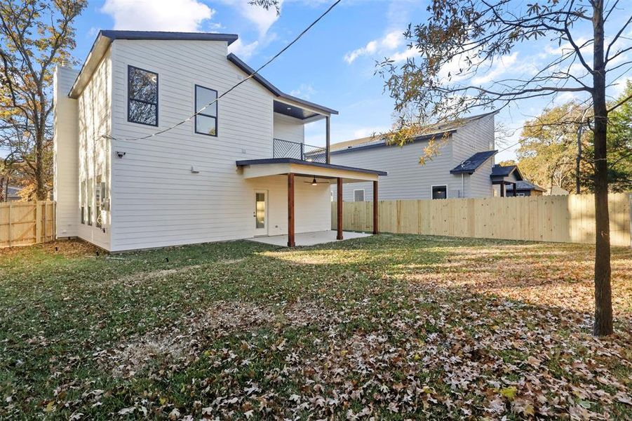 Back of property with a patio area and a yard