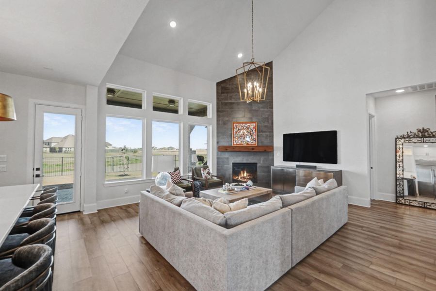 The main floor features an integrated layout connecting the gourmet kitchen, dining, and great room. Highlights include a floor-to-ceiling stone fireplace.
