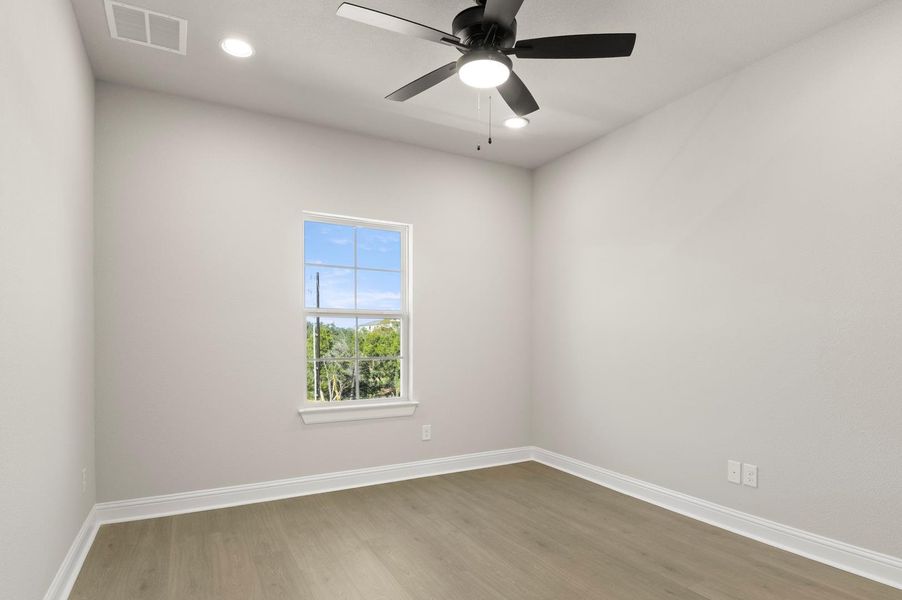 Empty room with wood finished floors, recessed lighting, and ceiling fan Empty room with wood finished floors, recessed lighting, and ceiling fan