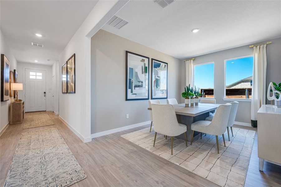 Dining area with light wood-type flooring and plenty of natural light