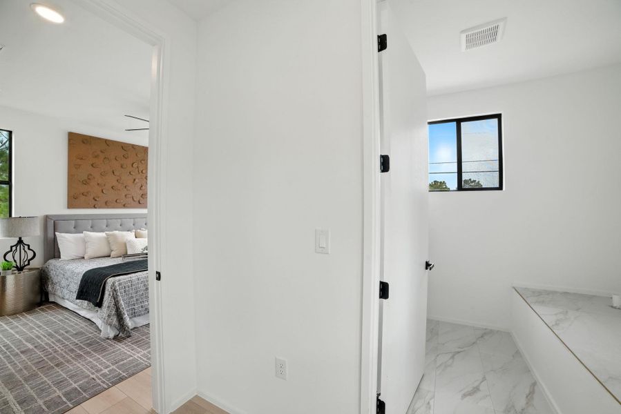 Bathroom featuring marble finish flooring and baseboards Bathroom featuring marble finish flooring and baseboards