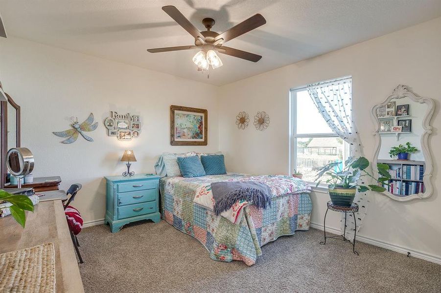 Bedroom with carpet flooring and ceiling fan Bedroom with carpet flooring and ceiling fan