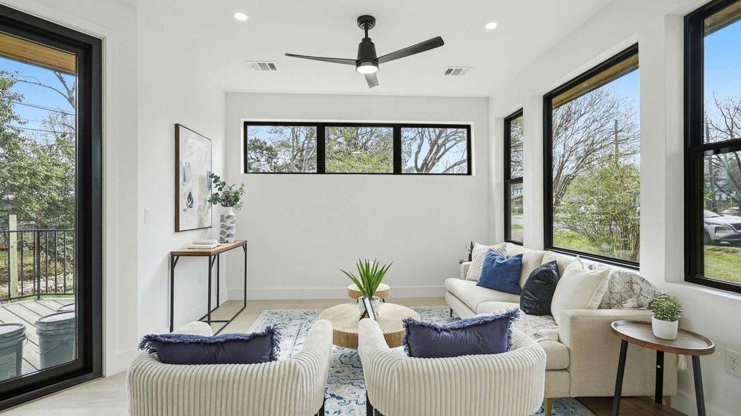 Sitting room with recessed lighting, healthy amount of natural light, and a ceiling fan