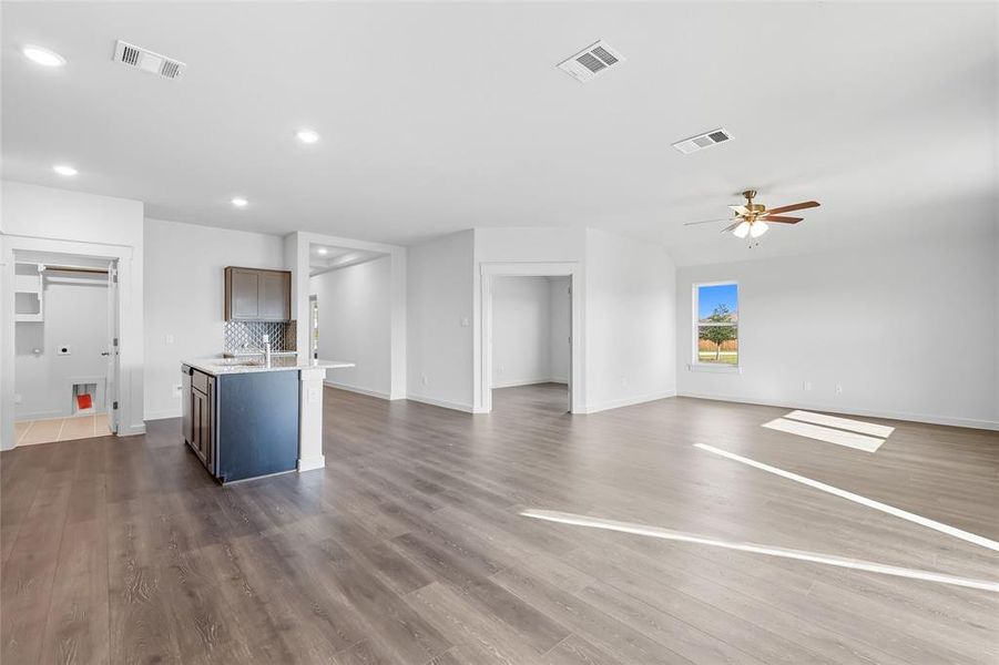 Unfurnished living room with dark wood-style flooring, recessed lighting, and a ceiling fan Unfurnished living room with dark wood-style flooring, recessed lighting, and a ceiling fan
