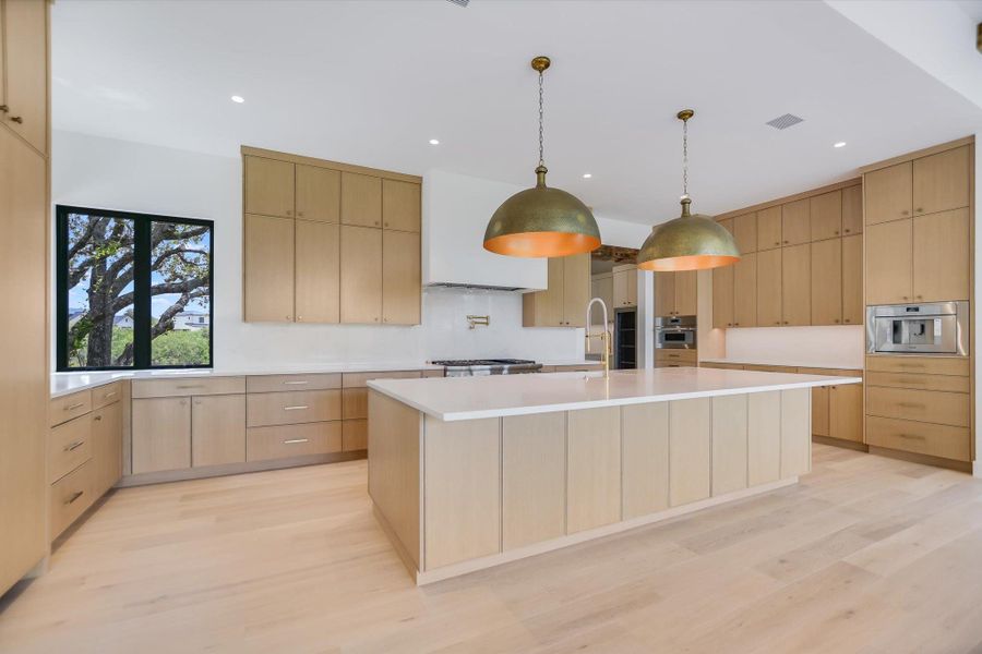 Culinary delights await in this bright, contemporary kitchen with generous counter space and seamless cabinetry.