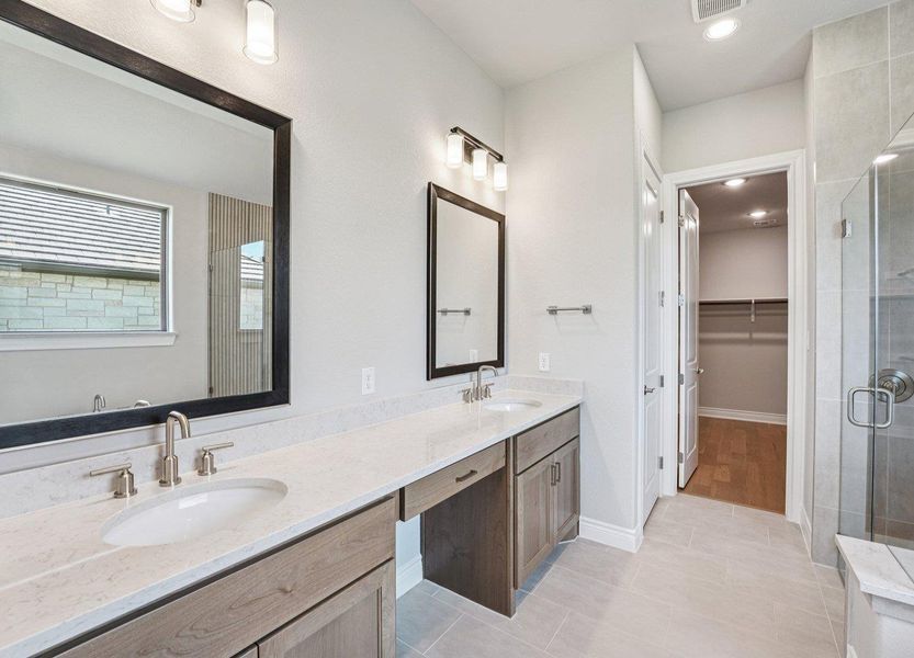 Full bath featuring a shower stall, double vanity, tile patterned floors, a spacious closet, and recessed lighting